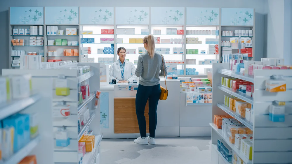 a woman standing at a counter in a pharmacy / A Complete Guide to the Medication Therapy Management Program / What Is a Medication Therapy Management Program? / Key Components of a Medication Therapy Management Program / Who Can Benefit From MTM Programs? / Benefits of Medication Therapy Management / How to Enroll in a Medication Therapy Management Program / Local Pharmacies Offering MTM Services / Role of Pharmacists in MTM / Medication Therapy Management vs. Regular Pharmacy Services / Monitoring and Personalized Care / Why Medication Therapy Management Matters / Pharmacy CareRX