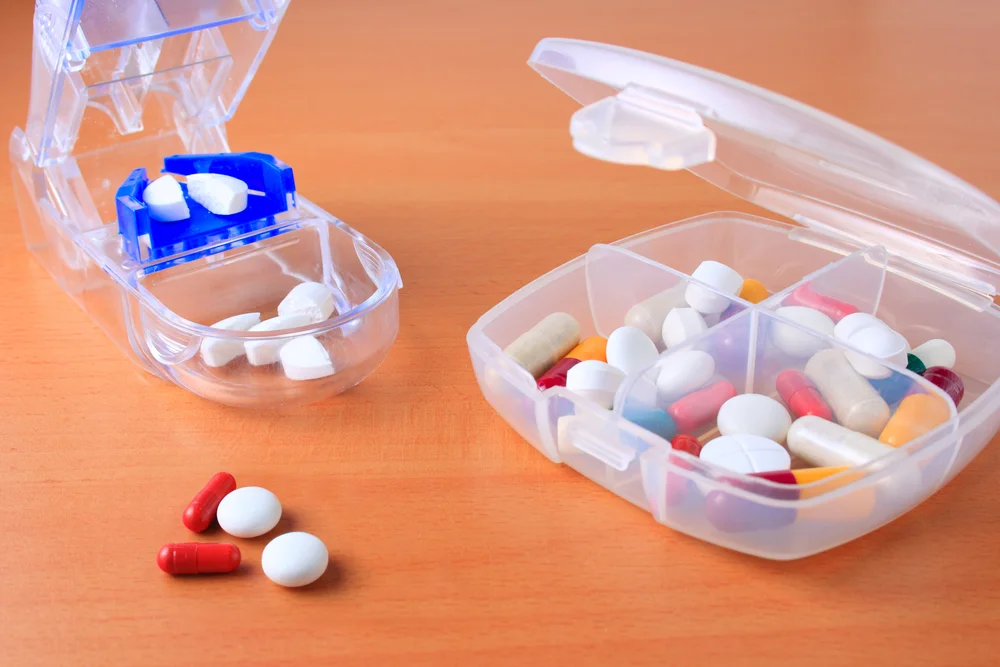 a plastic container with pills in it / Pill Splitting Guide: How to Safely Cut a Pill / What is Pill Splitting and Why Does It Work? / Is Pill Splitting Legal and Safe? / What Kinds of Pills Can Be Split? / Pills You Should NEVER Split / What Could Go Wrong with Pill Splitting? / How to Split Pills the Right Way / Tips for Safe Storage and Use of Split Pills / Talk to Your Doctor First – Always / Is Pill Splitting the Best Option for You / Alternatives to Pill Splitting: Other Cost-Saving Options / Be Smart, Be Safe: Important Reminders for Pill Splitting / Pharmacy Care RX