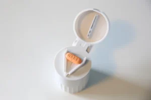 a pill in a plastic container Pill Splitting Guide: How to Safely Cut a Pill / What is Pill Splitting and Why Does It Work? / Is Pill Splitting Legal and Safe? / What Kinds of Pills Can Be Split? / Pills You Should NEVER Split / What Could Go Wrong with Pill Splitting? / How to Split Pills the Right Way / Tips for Safe Storage and Use of Split Pills / Talk to Your Doctor First – Always / Is Pill Splitting the Best Option for You / Alternatives to Pill Splitting: Other Cost-Saving Options / Be Smart, Be Safe: Important Reminders for Pill Splitting / Pharmacy Care RX