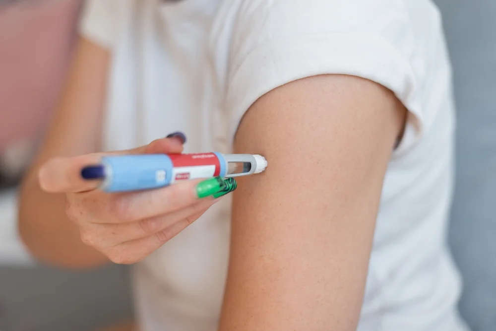 a person injecting a person's arm / Weight-Based Medication Dosing: A Complete Guide / What is Weight-Based Medication Dosing? / Why is Weight-Based Dosing Important? / How is Weight-Based Medication Dosing Calculated? / Applications of Weight-Based Medication Dosing / Common Medications That Use Weight-Based Dosing / Factors to Consider in Weight-Based Dosing / Challenges in Weight-Based Dosing / FAQs on Weight-Based Medication Dosing / Pharmacy Care RX