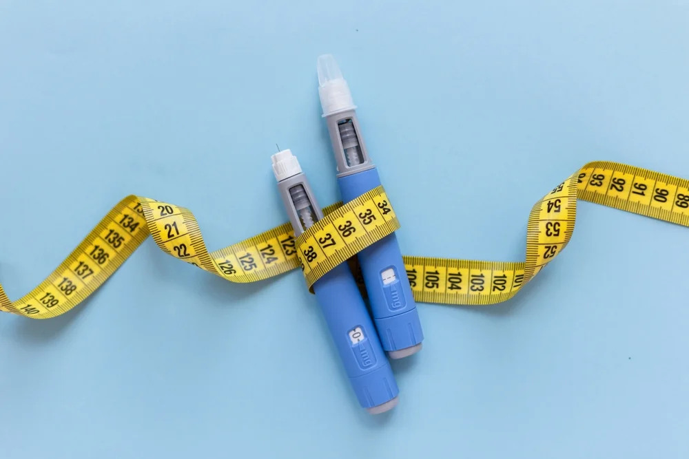 a measuring tape wrapped around two insulin pens / Weight-Based Medication Dosing: A Complete Guide / What is Weight-Based Medication Dosing? / Why is Weight-Based Dosing Important? / How is Weight-Based Medication Dosing Calculated? / Applications of Weight-Based Medication Dosing / Common Medications That Use Weight-Based Dosing / Factors to Consider in Weight-Based Dosing / Challenges in Weight-Based Dosing / FAQs on Weight-Based Medication Dosing / Pharmacy Care RX