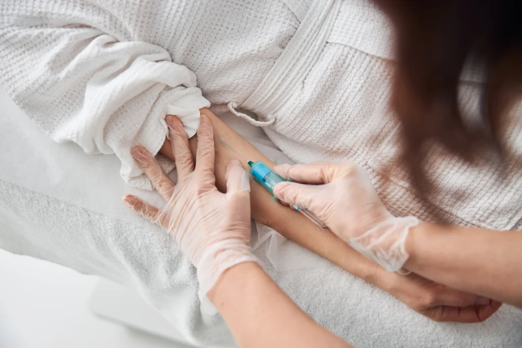a doctor injecting a dose of humira injection
