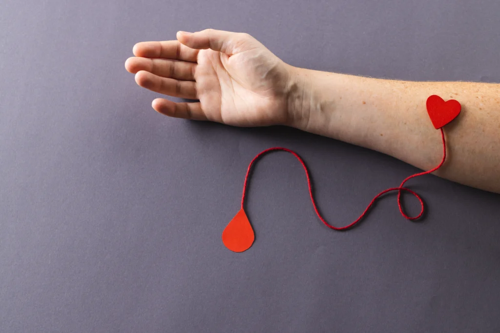 arm of caucasian woman with heart and red string