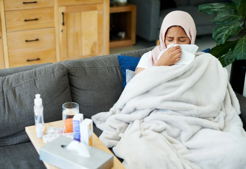 a woman suffering from flu virus in the flu season 2025