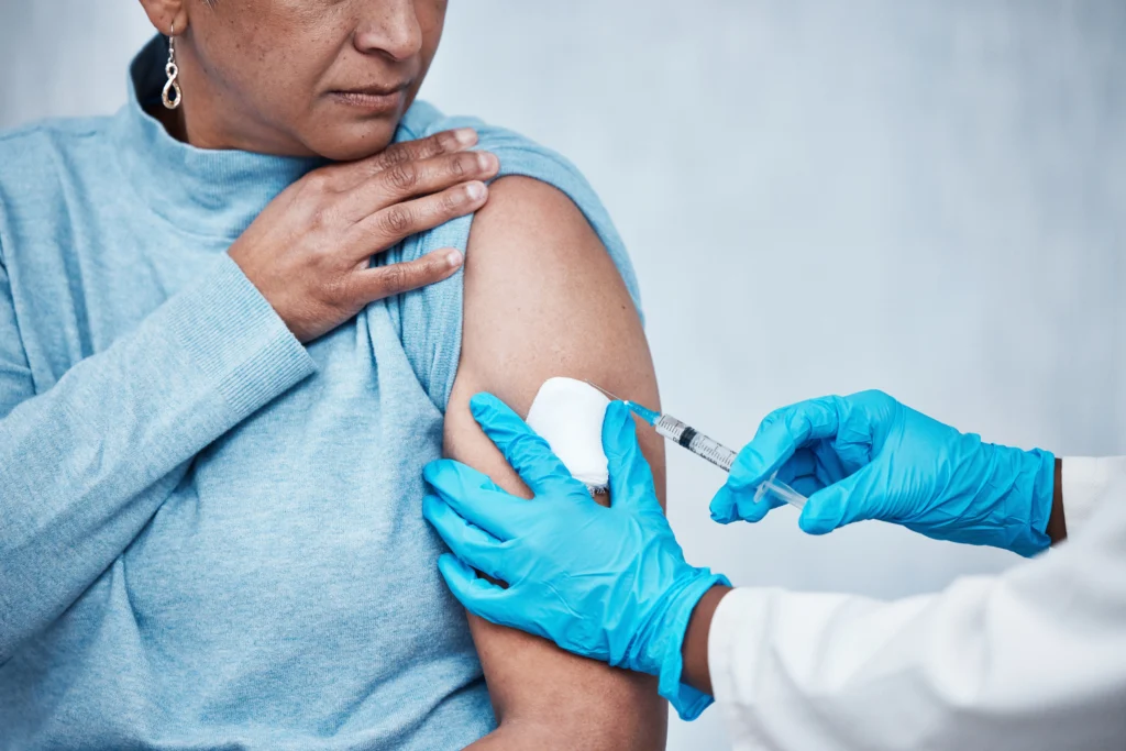 a woman getting injected with a dose of flu vaccine