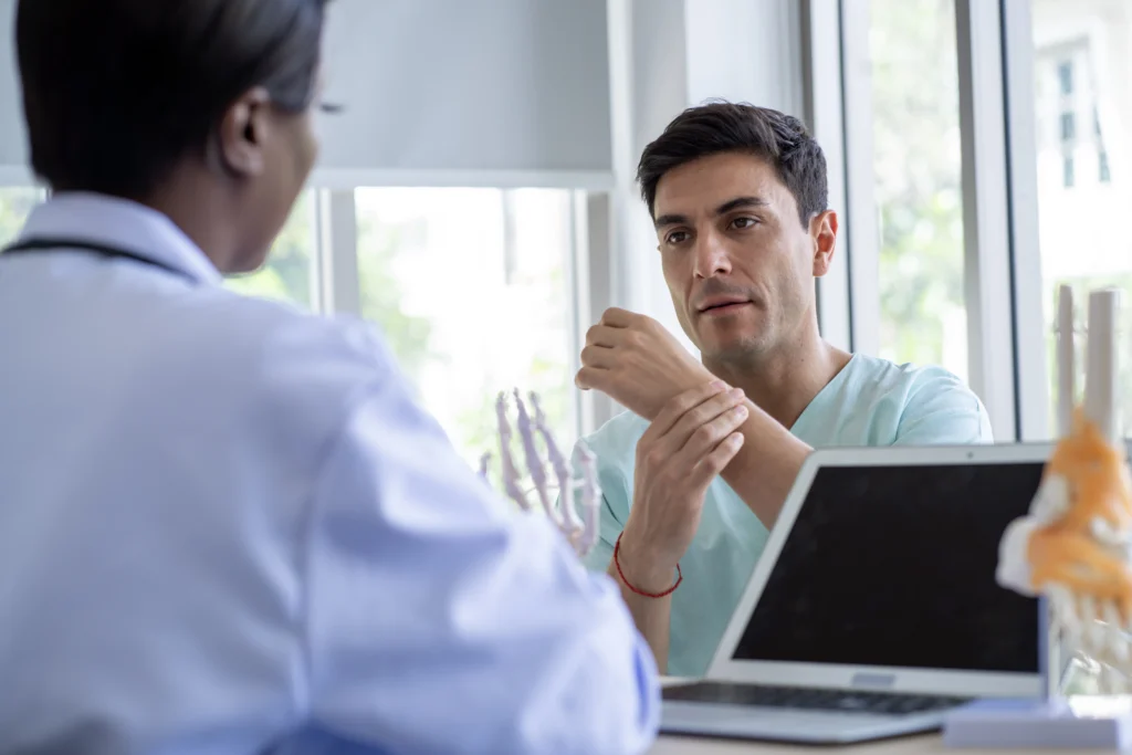 A man explaining ankle pain to his doctor because he has Missed a Dose of Methotrexate