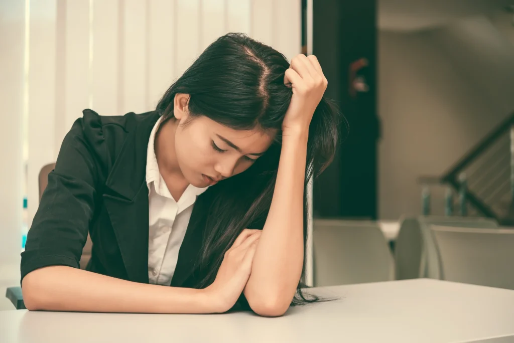 A woman exeriencing fatigue and low energy due to Side Effects of Missing a Dose of Adderall