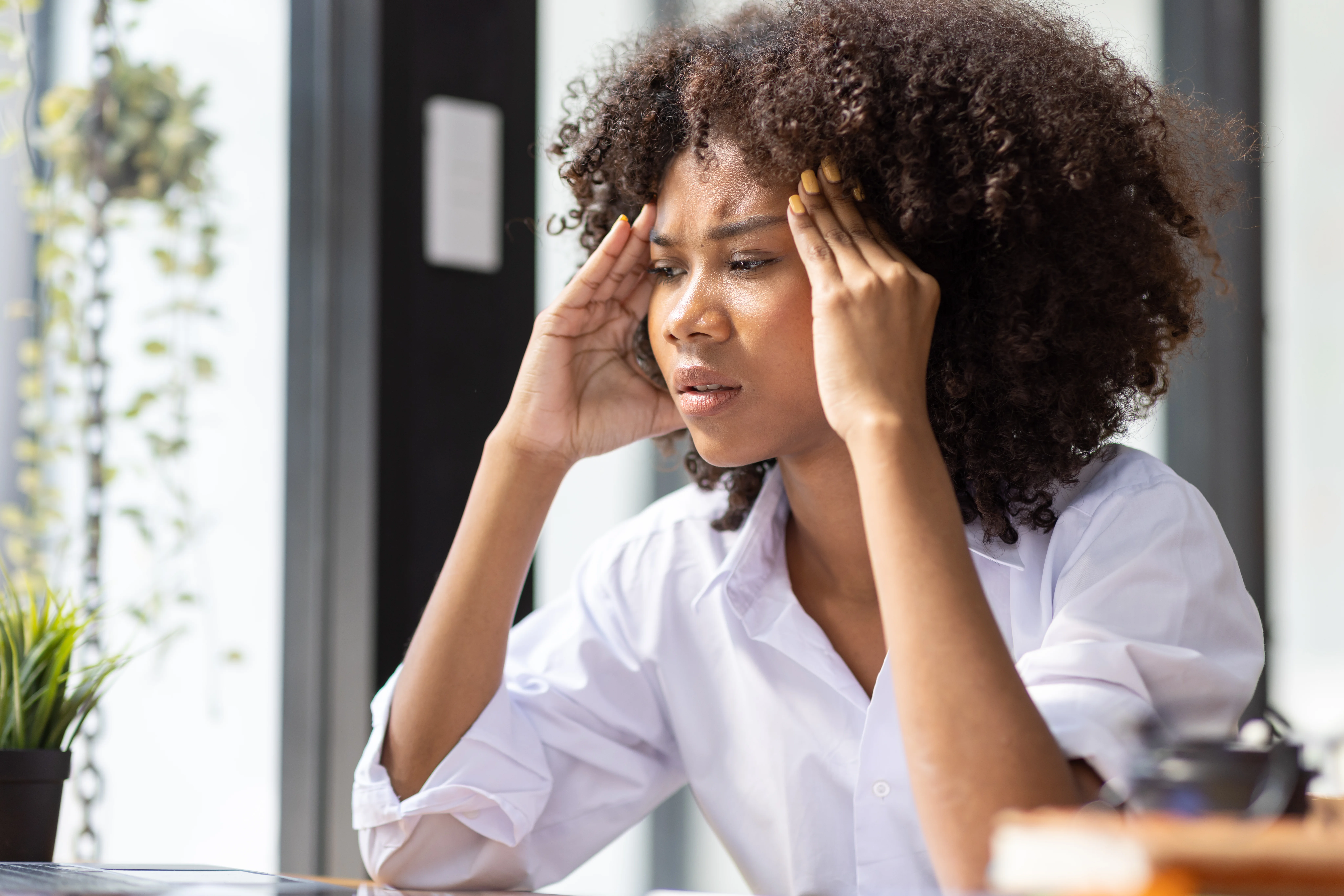 A woman experiencing headache due to Side Effects of Missing a Dose of Escitalopram