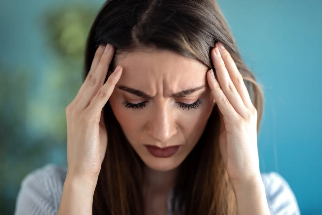 A woman experiencing Headache due to Side Effects of Missing a Dose of Albuterol