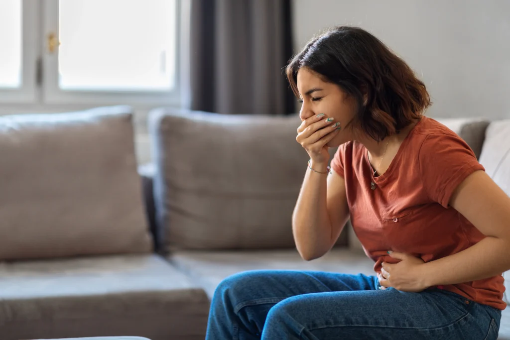 Woman experiencing nausea as a possible side effect of metformin