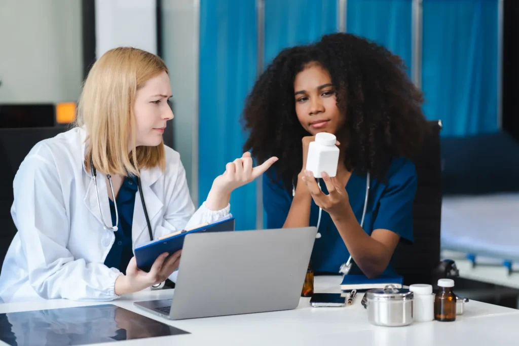 Healthcare professional discussing medication side effects with a patient