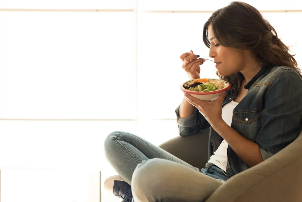Woman eating a meal while experiencing increased appetite from methylprednisolone