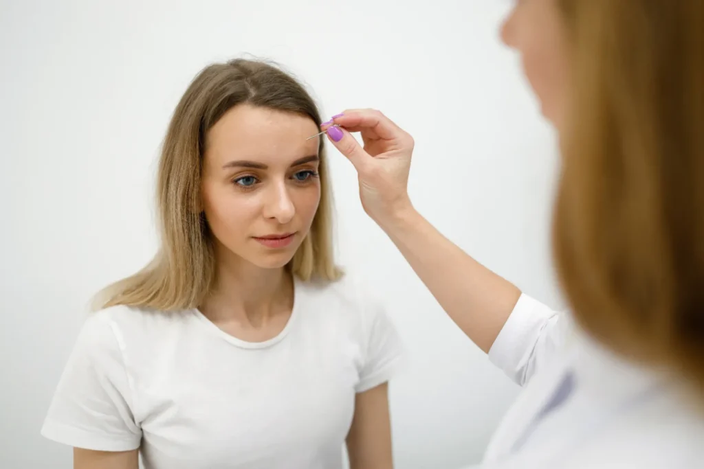 Doctor examining woman's hair to identify the cause of hair loss
