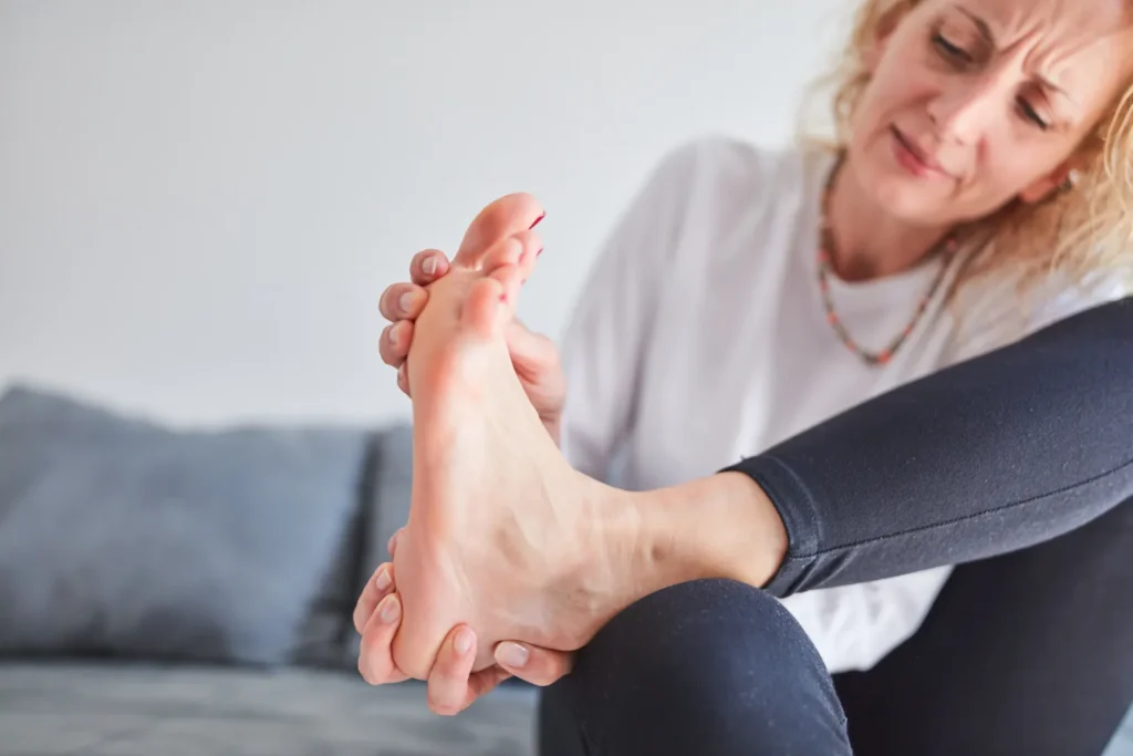 Woman experiencing mild swelling and discomfort in her foot