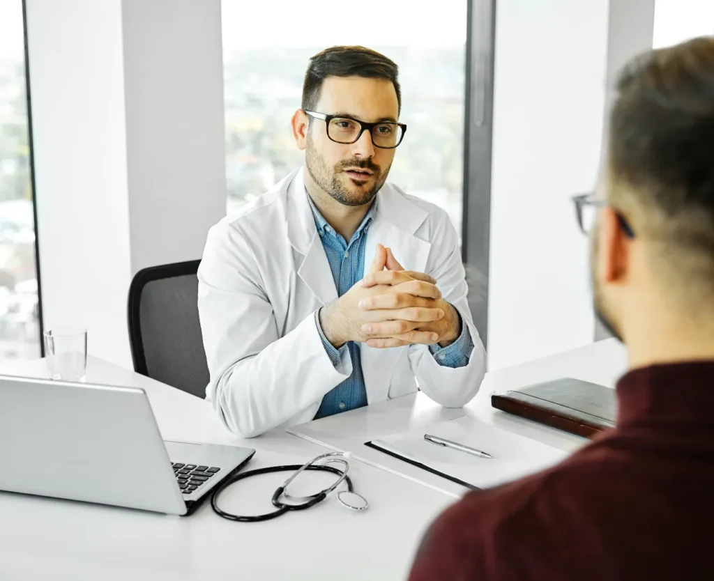 Doctor discussing atorvastatin medication and treatment with a patient during a medical consultation